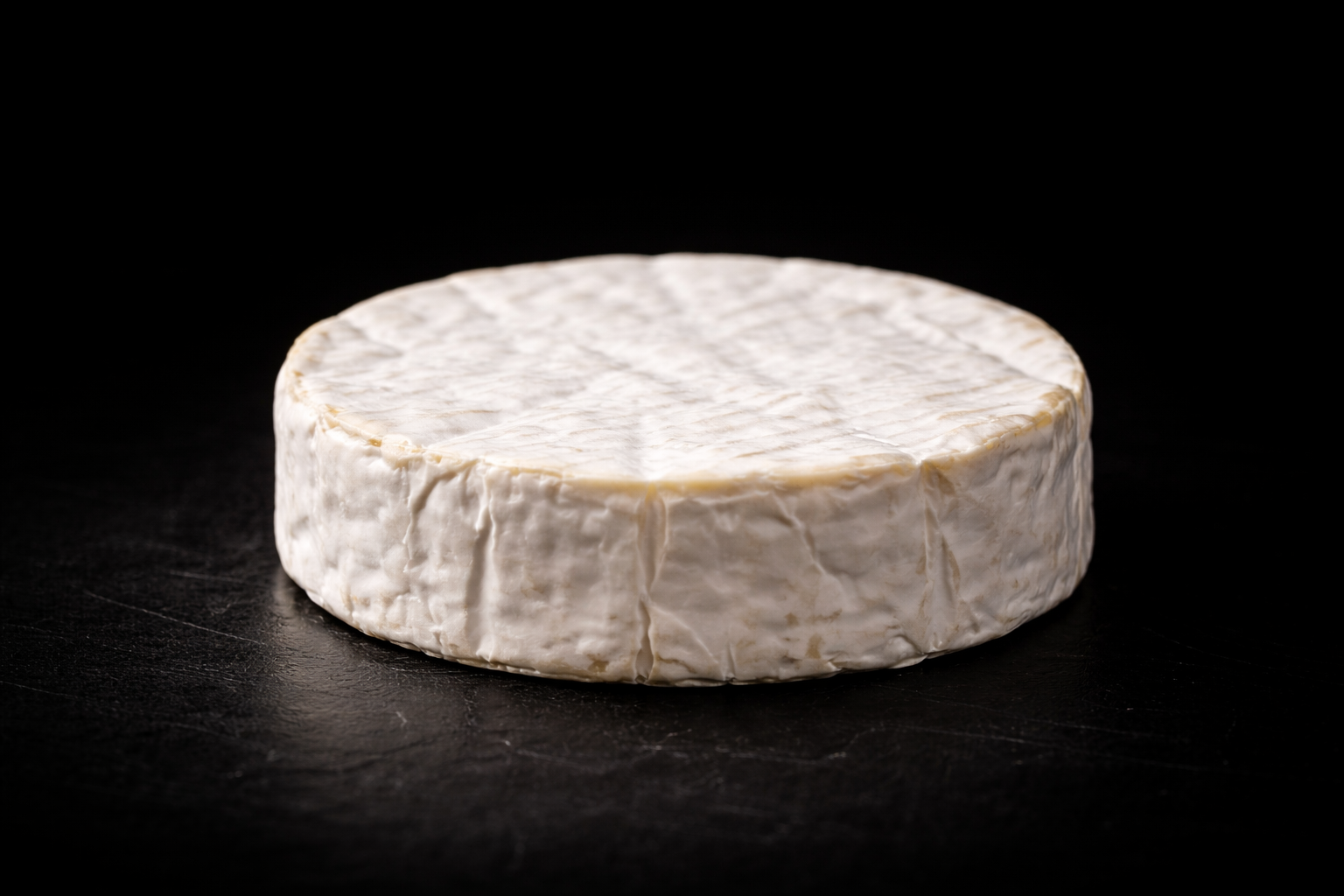 Soft cheese on a dark background